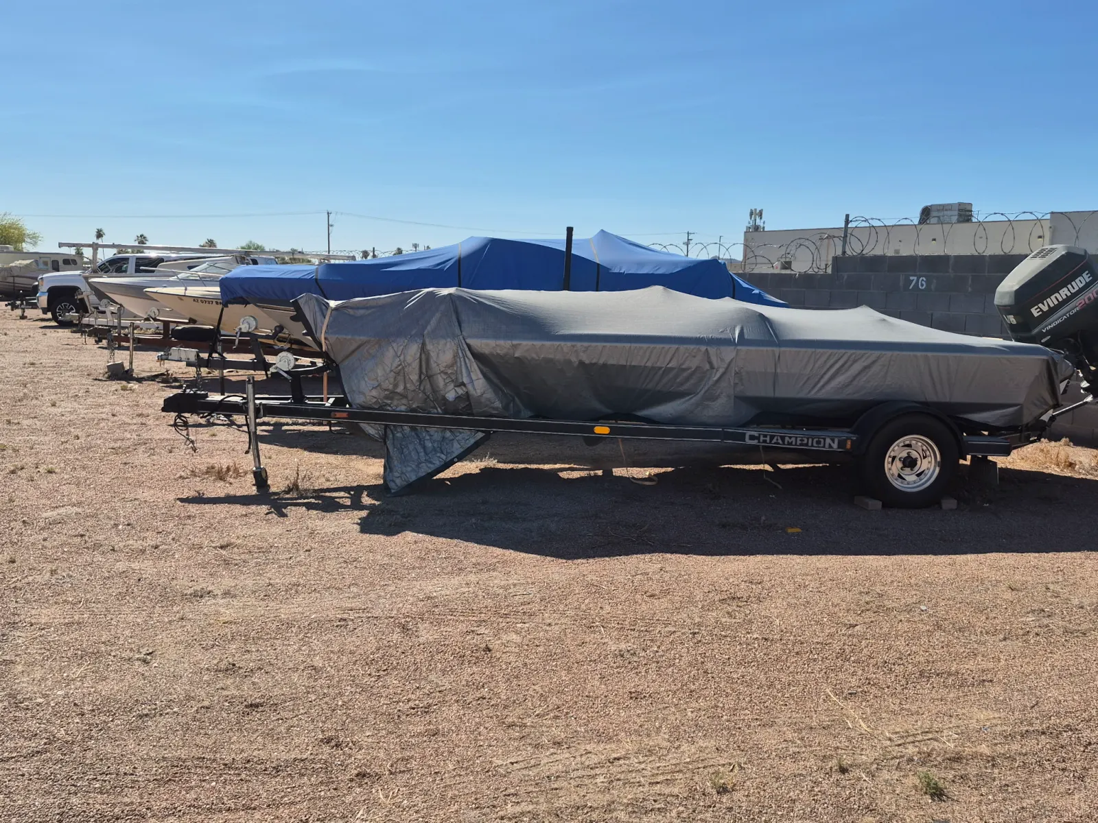 Covered boats parked in the storage yard