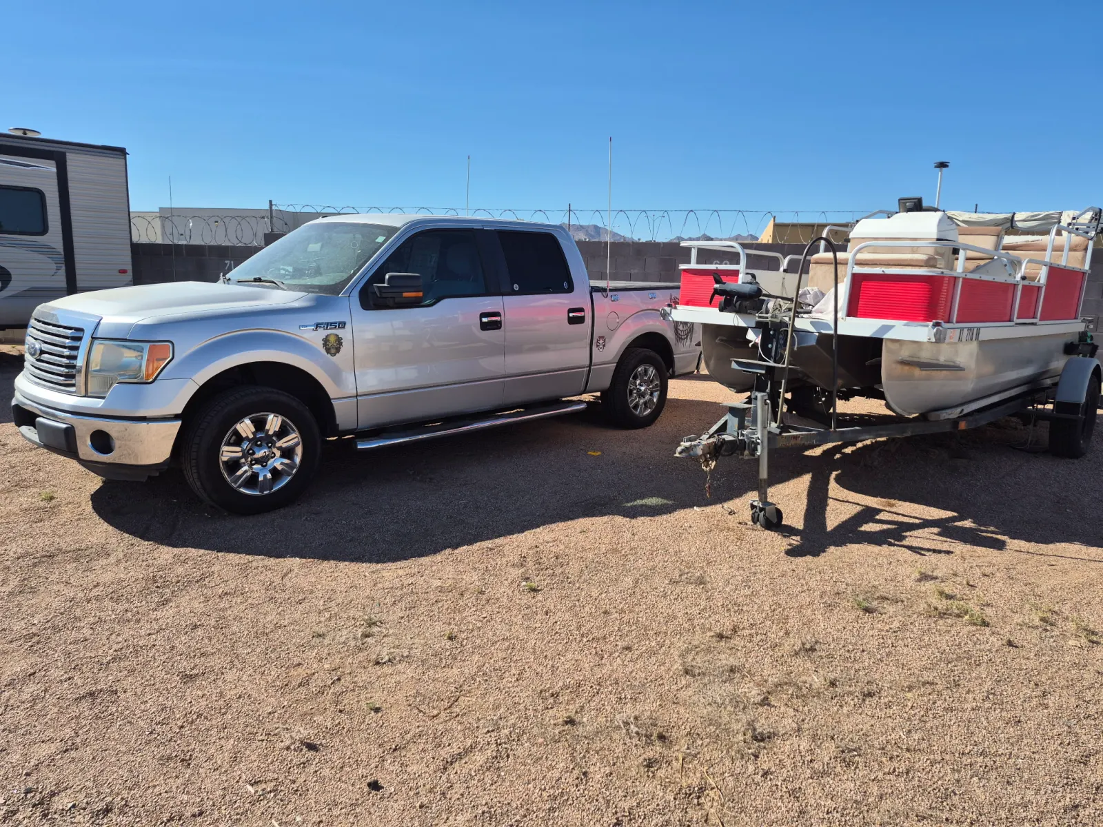 Pickup truck and pontoon boat in the storage yard